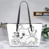 Happy corgi with a butterfly on its nose in a garden leather tote bag