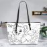 Happy corgi with a butterfly on its nose in a garden leather tote bag