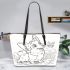 Happy corgi with a butterfly on its nose in the garden leather tote bag