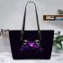 Purple frog with bright green eyes and on a solid leaather tote bag