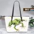 Simple cute cartoon drawing of green frog jumping leaather tote bag