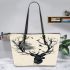 The silhouette of a deer head made from branches leather totee bag