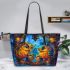 Two colorful owls sitting on the edge of an ornate mirror leather tote bag