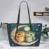 Two cute owls in love hugging each other on the moon leather tote bag