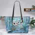 Two cute owls with feathers in shades of blue leather tote bag