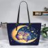 Two owls in love sitting on the crescent moon leather tote bag