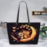 Two owls in love sitting on the crescent moon leather tote bag