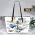 Watercolor dragonfly among flowers leather tote bag