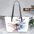 Watercolor dragonfly sitting on flower leather tote bag