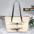 Watercolor dragonfly sitting on top of flower leather tote bag