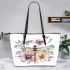 Watercolor dragonfly surrounded in the style of flowers leather tote bag