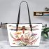 Watercolor dragonlfly perched on top of flowers leather tote bag