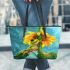 Adorable cartoon frog hanging onto the stem of a sunflower in full bloom leaather tote bag