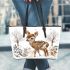 Baby deer in the snow leather totee bag