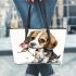 Beagle puppy holding a pink rose in its mouth leather tote bag