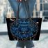 Blue owl sitting on an intricate dreamcatcher leather tote bag