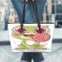 Cartoon frog sticking its tongue out in a cute leaather tote bag