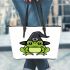 Cartoon green frog wearing black witch hat leaather tote bag