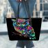 Colorful owl with glowing eyes perched leather tote bag