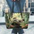 Cute baby panda is eating bamboo leaves in the forest leather tote bag