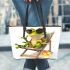 Cute cartoon frog sitting in the sun on an outdoor chair leaather tote bag