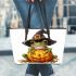 Cute cartoon frog wearing a witch hat sitting on a pumpkin leaather tote bag