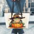 Cute cartoon frog wearing a witch hat sitting on a pumpkin leaather tote bag