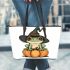 Cute cartoon frog wearing a witch's hat sitting on a pumpkin leaather tote bag