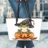 Cute cartoon frog wearing a witch's hat sitting on a pumpkin leaather tote bag