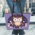 Cute cartoon owl sitting on a branch leather tote bag