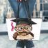 Cute cartoon owl with glasses and graduation hat holding book leather tote bag