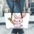 Cute cartoon rabbit holding a carrot leather tote bag