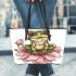 Cute frog sitting on the flower leaather tote bag
