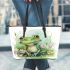 Cute frog sitting on the grass with flowers leaather tote bag