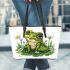 Cute frog sitting on the grass with flowers leaather tote bag