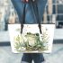 Cute frog sitting on the ground with flowers leaather tote bag