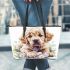 Cute golden retriever puppy with daisies and easter eggs leather tote bag