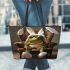 Cute green frog sitting in an armchair wearing white bunny slippers leaather tote bag