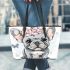 Cute grey french bulldog dog wearing a pink flower leather tote bag