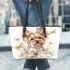 Cute little yorkshire terrier with long hair and bows in her ears leather tote bag