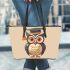 Cute owl wearing glasses and a graduation hat in a simple leather tote bag