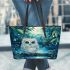 Cute owl with big blue eyes perched leather tote bag