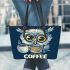 Cute owl with big yellow eyes holding a coffee cup leather tote bag