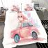 Cute pink owl sitting on top of a pastel car bedding set