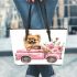 Cute pomeranian dog in a pink truck with flowers leather tote bag