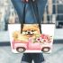 Cute pomeranian dog in a pink truck with flowers leather tote bag