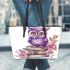 Cute purple owl sitting on top of books surrounded by pink roses leather tote bag