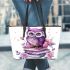 Cute purple owl sitting on top of books surrounded by pink roses leather tote bag