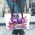 Cute purple owl sitting on top of books surrounded leather tote bag