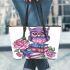 Cute purple owl sitting on top of books with pink roses leather tote bag